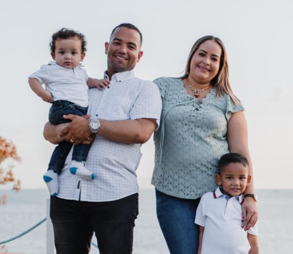 Family of four standing in a field and enjoying the weather